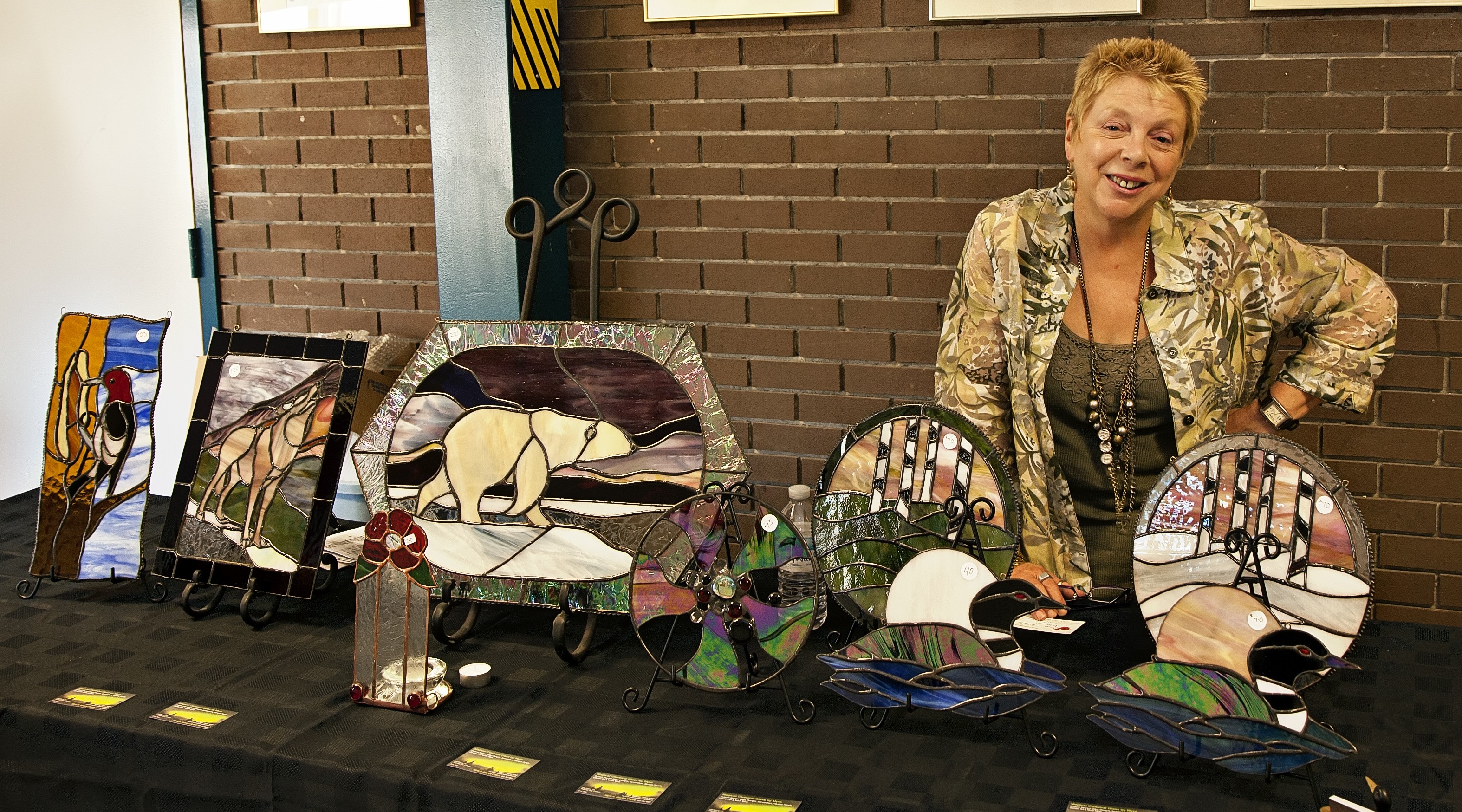 Myra standing behind some stained glass pieces